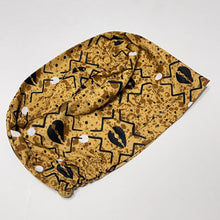Load image into Gallery viewer, Niceroy Surgical SCRUB CAP black cowries on Tan tribal fabric Europe style nursing caps African print fabric and satin lining option.
