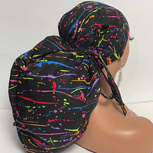 Load image into Gallery viewer, Satin lined 2XL JUMBO PONY Scrub Cap Black paint splatter cotton fabric surgical nursing hat and for Extra long/thick Hair/Locs