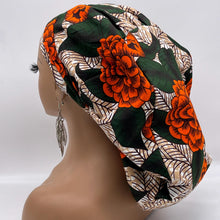 Load image into Gallery viewer, Ponytail SCRUB CAP off orange green floral cotton fabric surgical scrub hat nursing caps, satin lining option for long hair