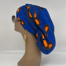 Load image into Gallery viewer, Adjustable Ankara PONY SCRUB CAP, cotton fabric surgical scrub hat Royal blue and Orange satin lining option for locs, braid, long hair